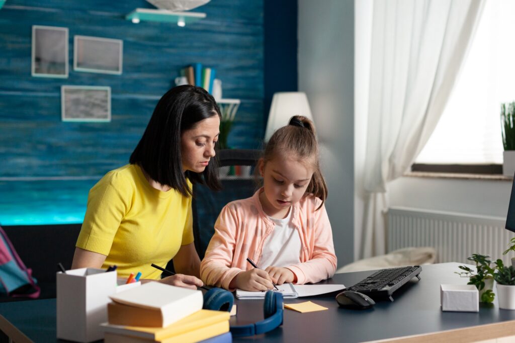 A child and parent doing homework together at home