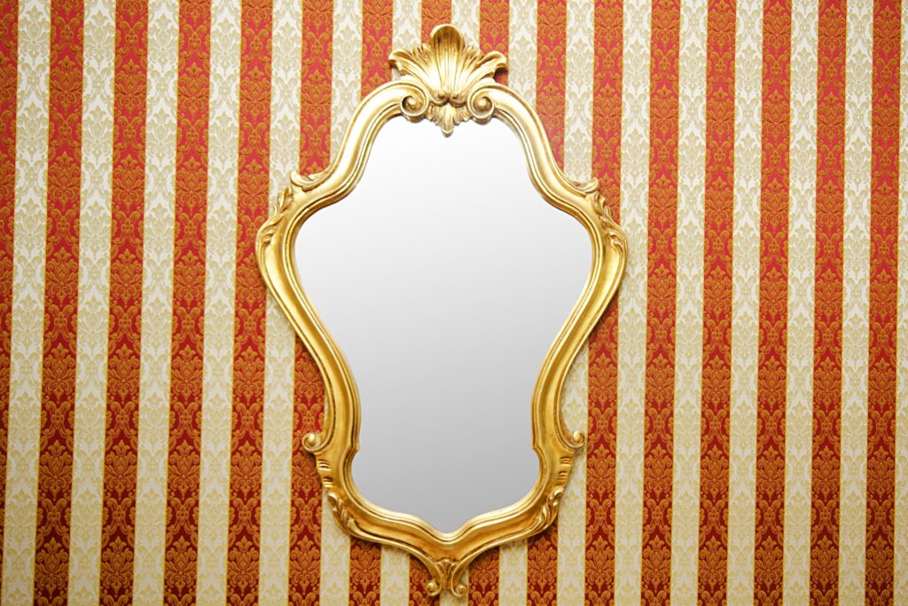 Ornate mirror on the wall with golden frame safely transported after the move